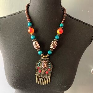 Boho style beaded necklace with rustic pendant. Wood and glass beads